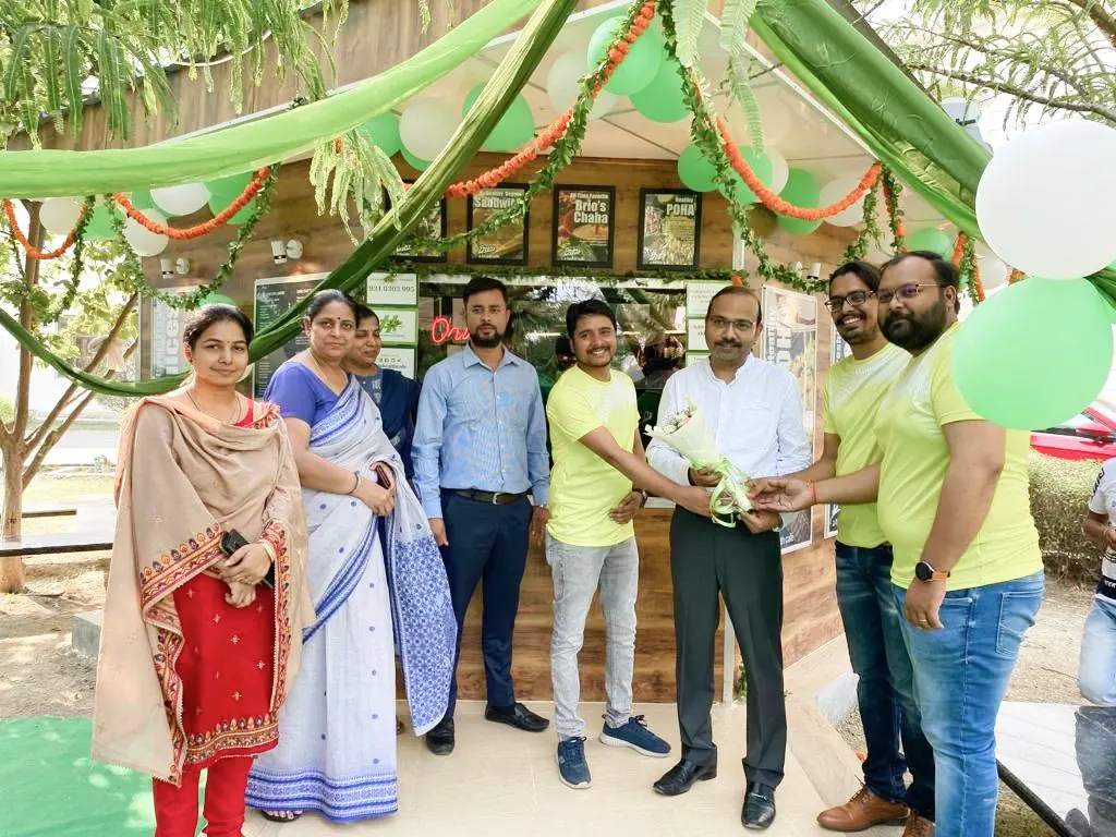 Guests and staff gathered at a BRIO kiosk decorated with garlands