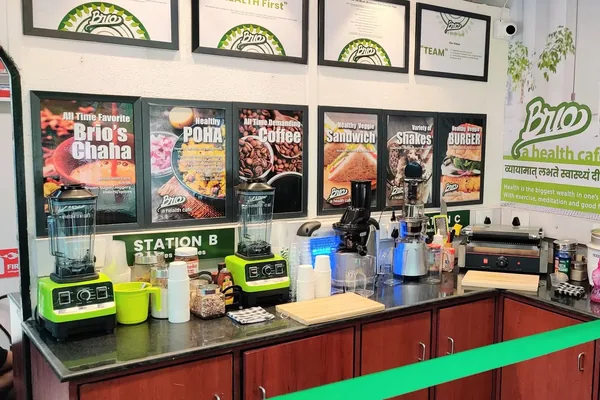 Inside a BRIO café: counter, blenders and framed menu posters