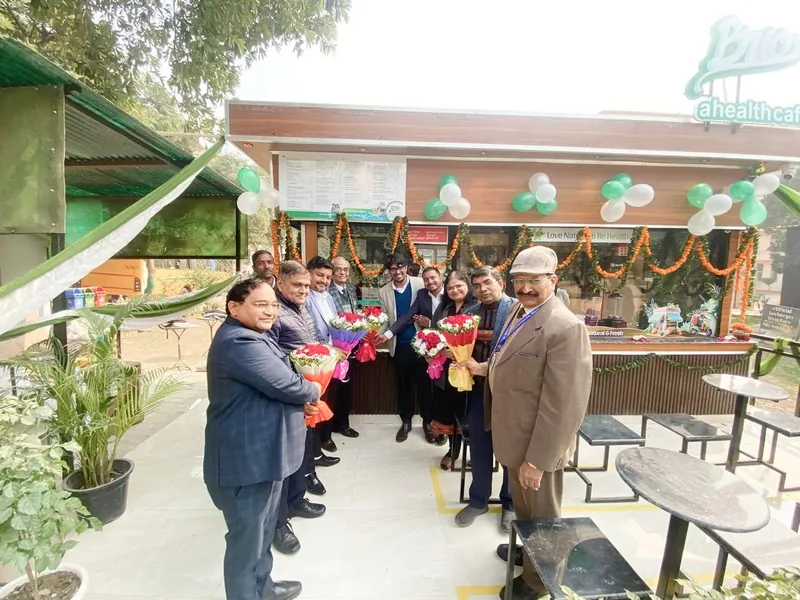Guests and staff lined up beside the BRIO RKGIT kiosk at its ribbon cutting